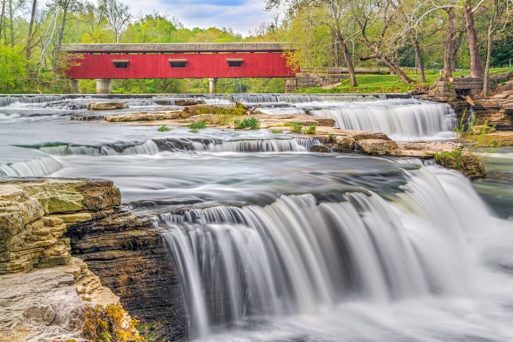 The historic red Cataract Covered Bridge crosses Indiana's Mill Creek