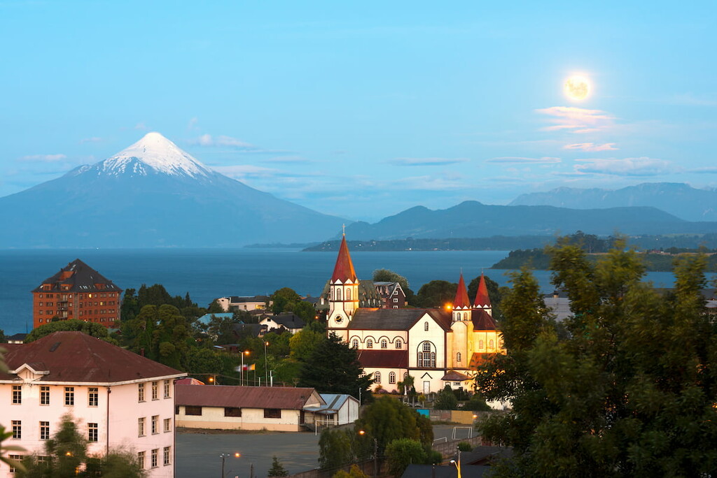 Moon rising on Puerto Varas at the shores of Lake Llanquihue with Osorno Volcano in the back, X Region de Los Lagos, Chile