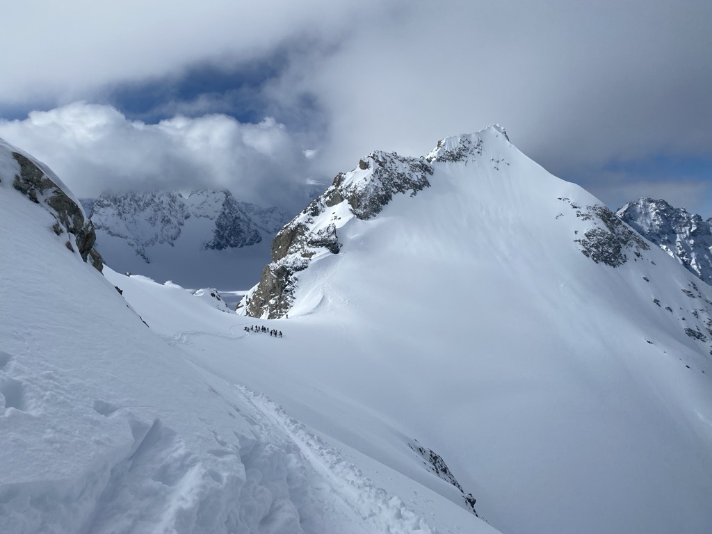 The army about to drop into the Glacier des Agneaux, and me standing behind at the Col Emile Pic. Photo: Anna Lochhead-Sperling. Journal des Ecrins Neige Cordier