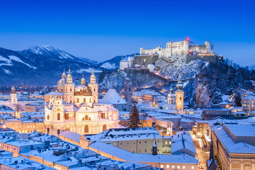 The Festung Hohensalzburg castle stands watch above the Salzburg city center during winter. Dachstein Mountains