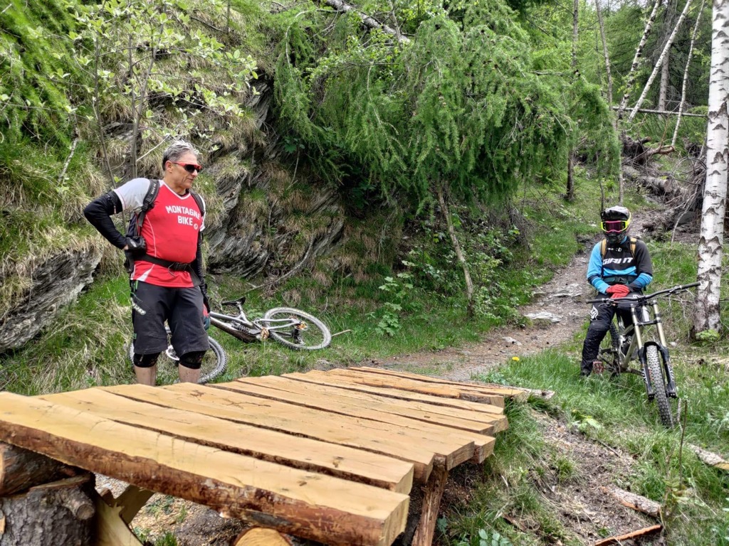 Inspecting a fresh, just-built wood feature at the bike park. Photo: Sergei Poljak. How to Start Mountain Biking