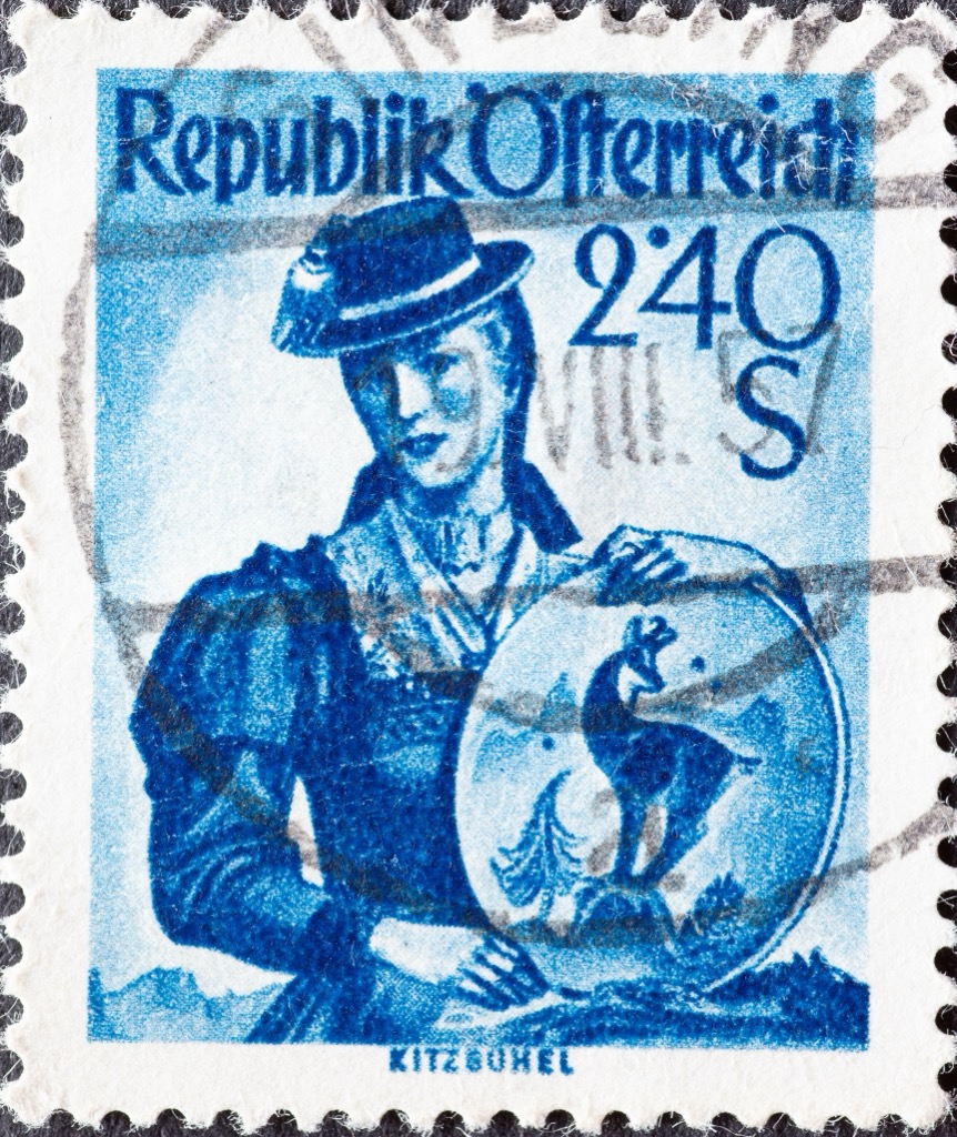 Postage stamp from 1951, showing a woman wearing the traditional tracht of Kitzbühel. Kitzbuehel Alps