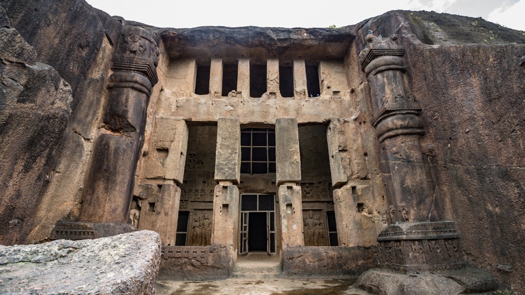 The carved facades of one of the entrances of Kanheri Caves. Maharashtra Mountains