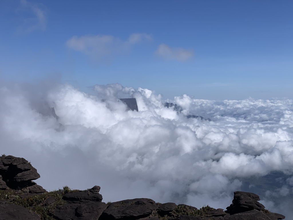 Clouds, cairns, and caves. Photo courtesy of Dimitri Tiunov