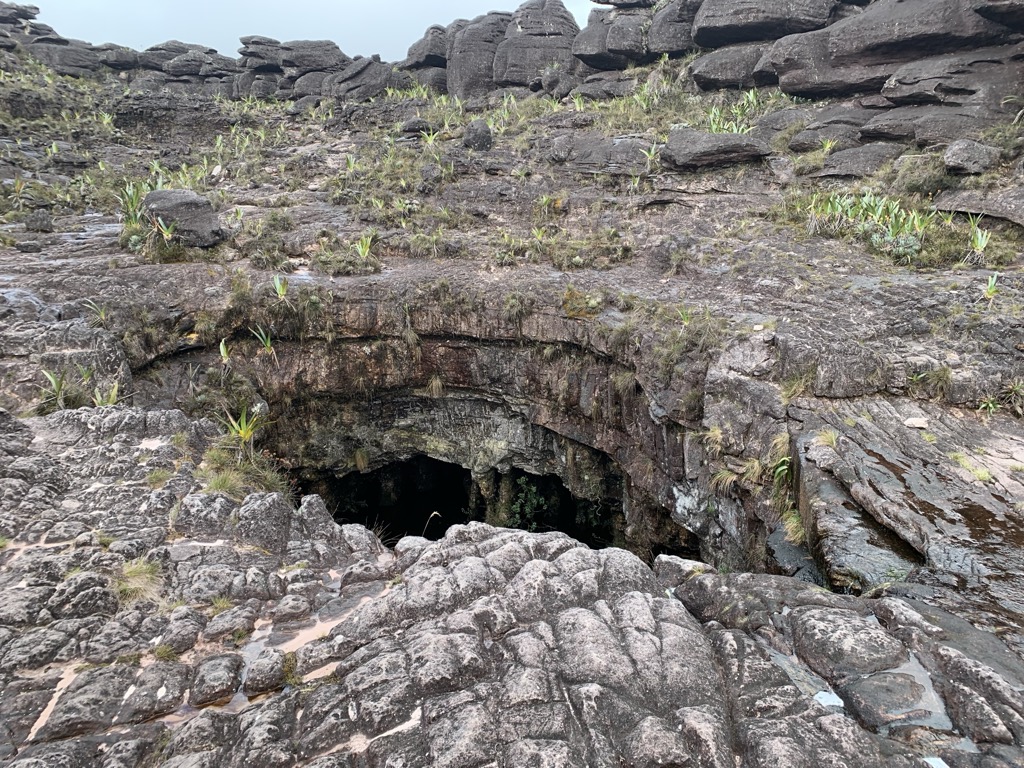 Clouds, cairns, and caves. Photo courtesy of Dimitri Tiunov
