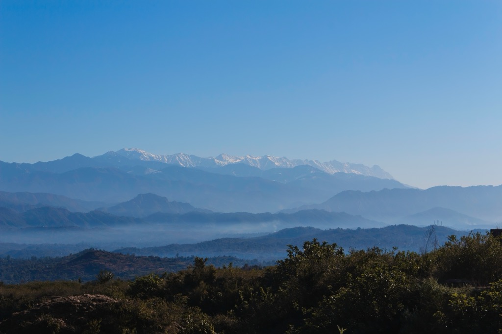 The Dhauladhar Mountains of Jammu and Kashmir towering in the distance, viewed from the Ranjit Sagar Dam in Punjab. While Punjab is flat, the Himalaya begins just to the north. Punjab Mountains