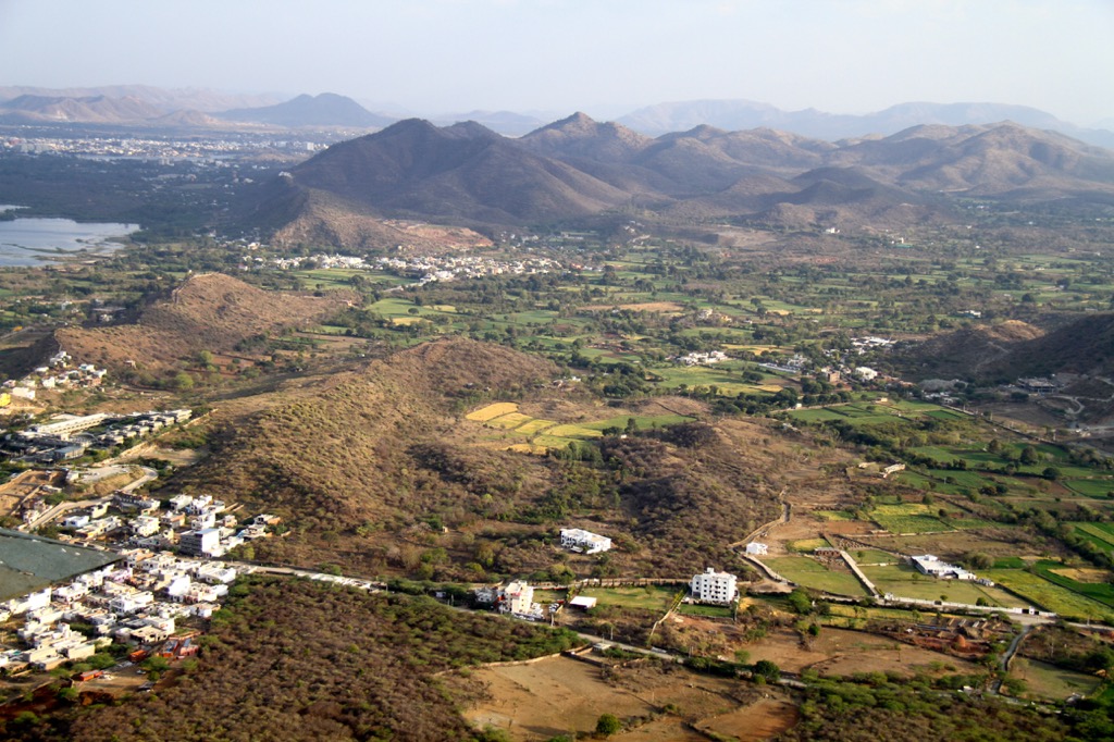 Fields and farmland surrounding the Aravalli Hills. Geography