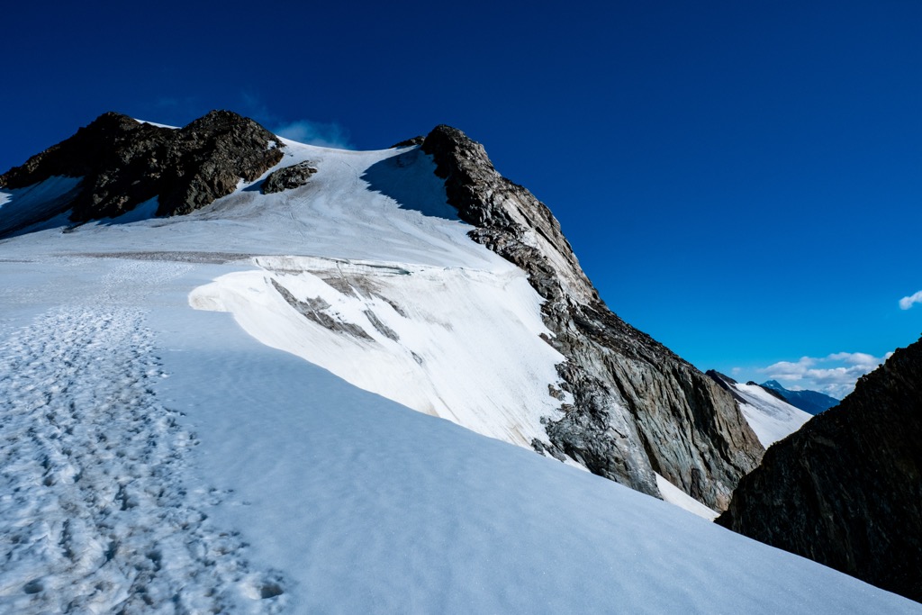 The summit of Weißkugel, with the tracks of mountaineers visible in the snow. Saldurkamm