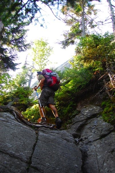 A hearty hiker heading over Burnt Rock Mountain at the close of a long day