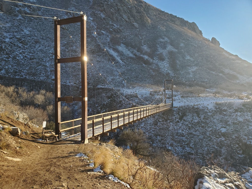 The trail features a pedestrian suspension bridge. Weber County