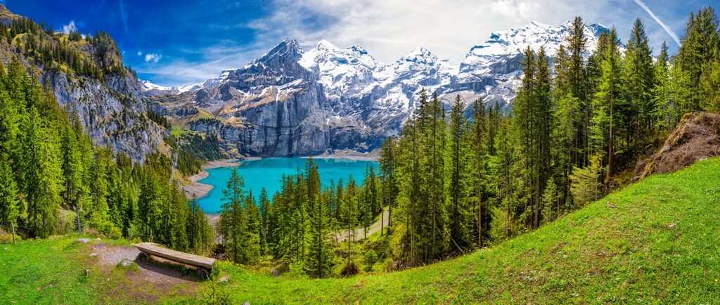 Amazing tourquise Oeschinnensee with waterfalls, wooden chalet and Swiss Alps, Berner Oberland,, Switzerland