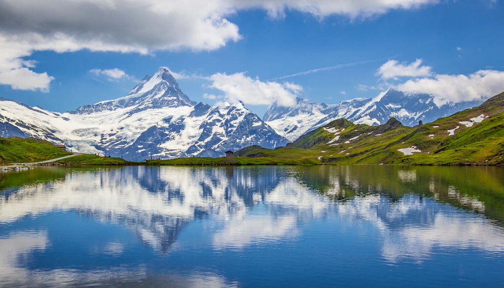 Finsteraarhorn peak reflected in the waters of the Bachalpsee lake, Pennine Alps